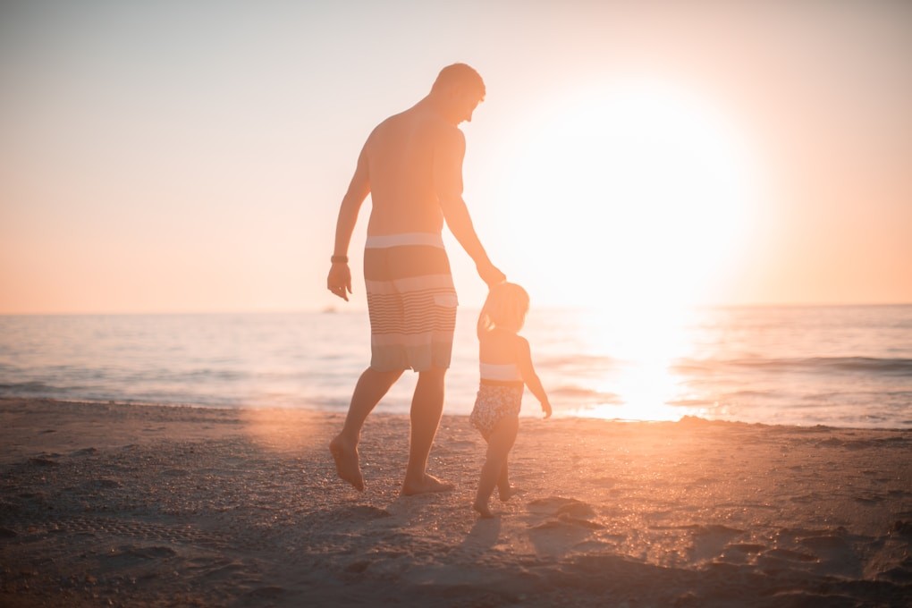 Father and daughter walking towards the beach. Sunshine Coast Naturopath