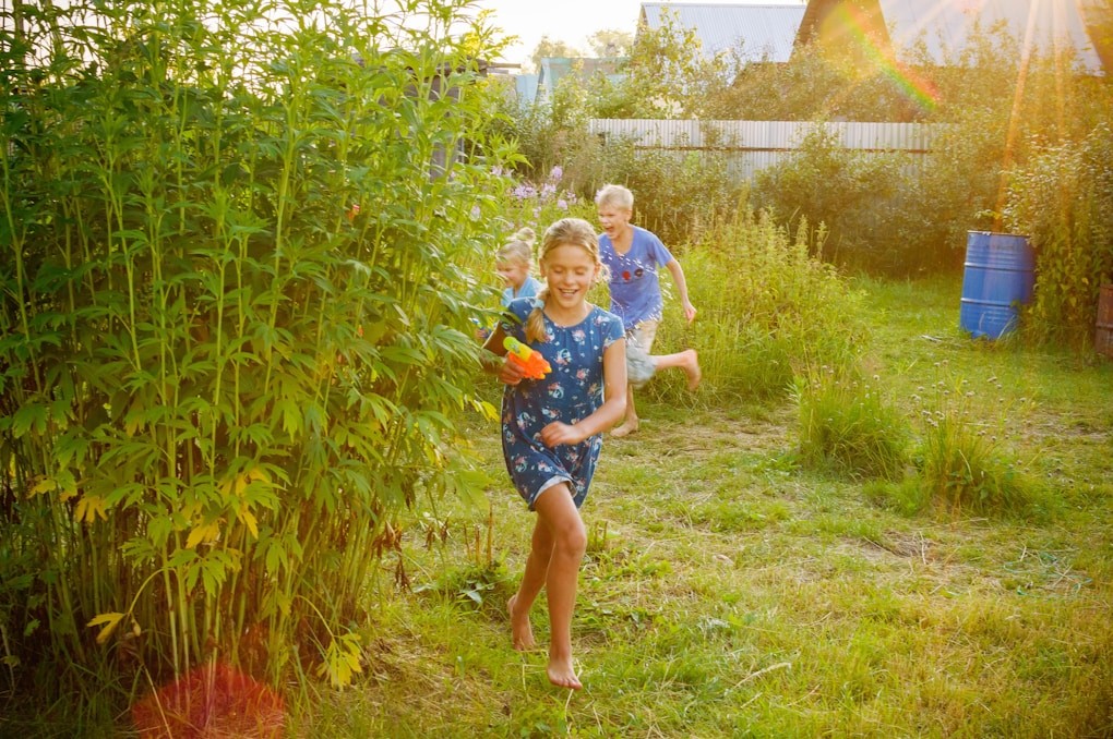 Girl in blue and white shirt standing on green grass field. Sunshine Coast Naturopath